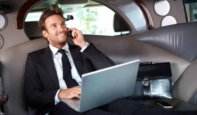 Man taking call in back of Luxury limousine, limo